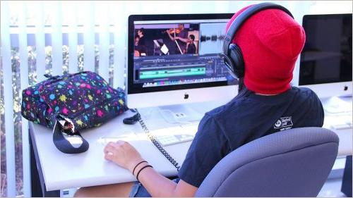 Student editing video in lab